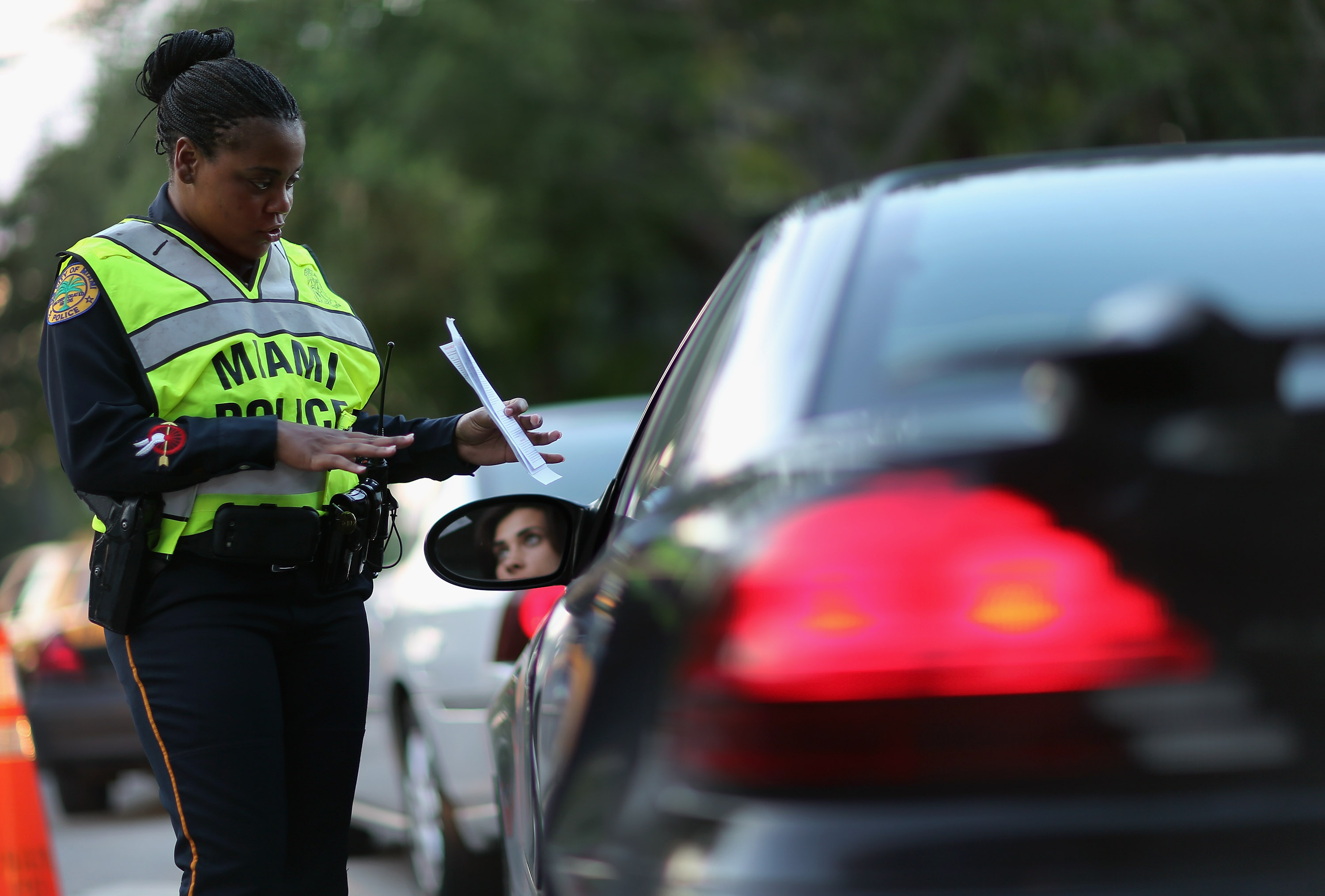 Police officer Lauren Miller speaks to a driver during a DUI checkpoint in Miami, Florida.