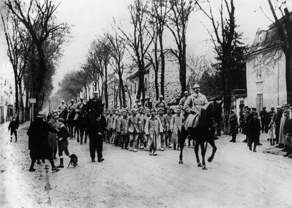 German prisoners captured at Verdun, are marched through the streets under mounted guard.