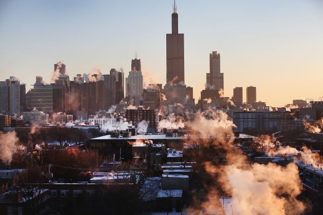 The sun rises behind the skyline as temperatures hovered around -10 degrees January 28, 2014 in Chicago, Illinois.