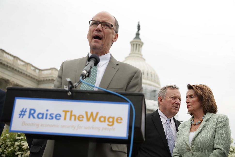 U.S. Labor Secretary Thomas Perez speaks as Senate Minority Whip Sen. Richard Durbin talks to House Minority Leader Rep. Nancy Pelosi during a news conference April 21, 2016 on Capitol Hill in Washington, DC.