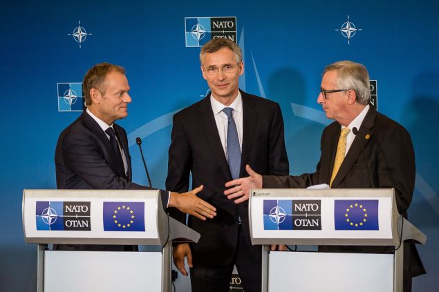 President of the European Council Donald Tusk (L) shakes hand with President of the European Commission Jean-Claude Juncker (R) in front of NATO Secretary General Jens Stoltenberg (C) during a joint press conference after signing the EU-NATO Joint Declaration at the NATO summit in Warsaw, Poland, on July 8, 2016.