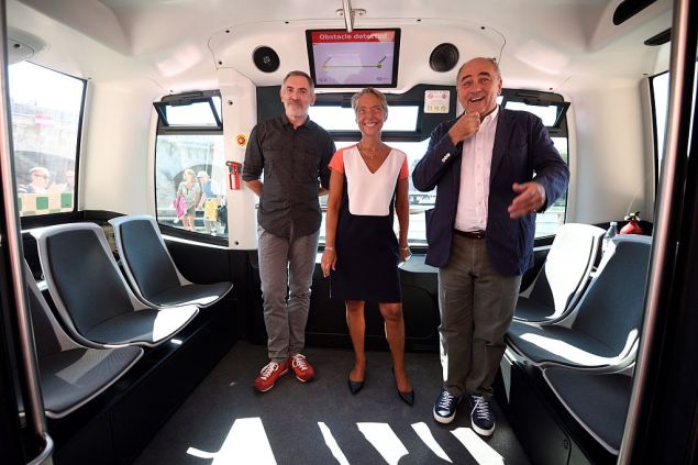 (From L) Director General of Easy Mile, Gilbert Gagnaire, CEO of the Paris Transport Authority RATP, Elisabeth Borne, and Paris Deputy mayor in charge of urbanism, architecture and projects, Jean-Louis Missika pose in a RATP electric-powered driverless EZ10 minibus, able to carry up to 12 passengers, as it carryies out its first test on the banks of the river Seine on September 24, 2016 in Paris. The RATP carries out its first test of a driverless minibus, in the hope that regular routes for the hi-tech vehicles will be up and running within two years. One of the self-driving shuttle buses, made by French hi-tech firm Easymile, run today along a special circuit in Paris on a pedestrianised street near the River Seine. / AFP / ERIC FEFERBERG (Photo credit should read ERIC FEFERBERG/AFP/Getty Images)