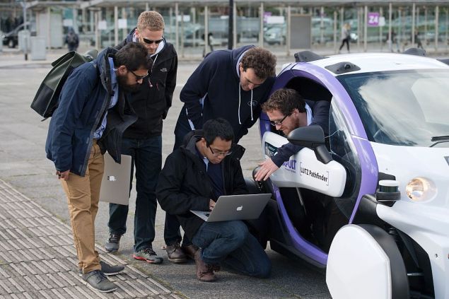 Technicans analise data follwong the trial of an autonomous self-driving vehicle in a pedestrianised zone, during a media event in Milton Keynes, north of London, on October 11, 2016. Driverless vehicles carrying passengers took to Britain's streets for the first time on Tuesday in a landmark trial which could pave the way for their introduction across the country. The compact two-seater cars trundled along a pedestrianised zone in Milton Keynes, north of London, in a trial by Transport Systems Catapult (TSC) which plans to roll out 40 vehicles in the city. / AFP / JUSTIN TALLIS (Photo credit should read JUSTIN TALLIS/AFP/Getty Images)