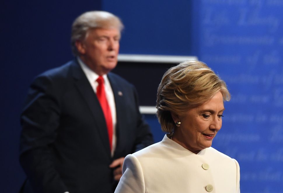 Hillary Clinton and Donald Trump walk off the stage after the final presidential debate at the Thomas & Mack Center on the campus of the University of Las Vegas in Las Vegas, Nevada on October 19, 2016.