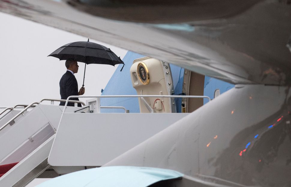 President Barack Obama boards Air Force One as he leaves for a day trip to Tampa, on December 6, 2016 at Joint Base Andrews, Maryland.