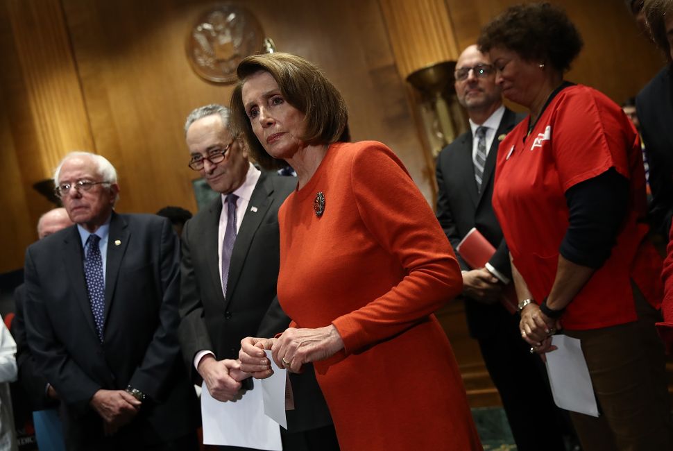 Rep. Nancy Pelosi, Sen. Chuck Schumer and Sen. Bernie Sanders listen to questions after addressing a press conference on Medicare benefits on Capitol Hill December 7, 2016 in Washington, DC.