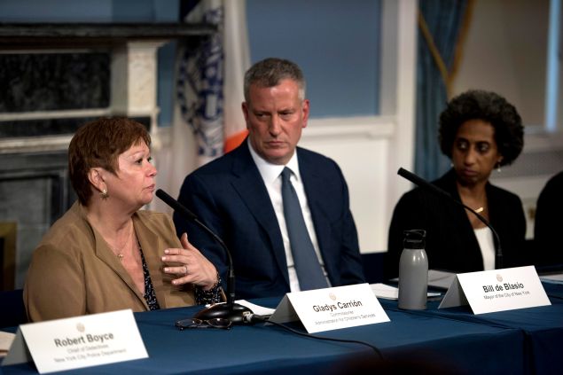 Former Administration for Children's Services Commissioner Gladys Carrión speaks as Mayor Bill de Blasio and Deputy Mayor Herminia Palacio look on.