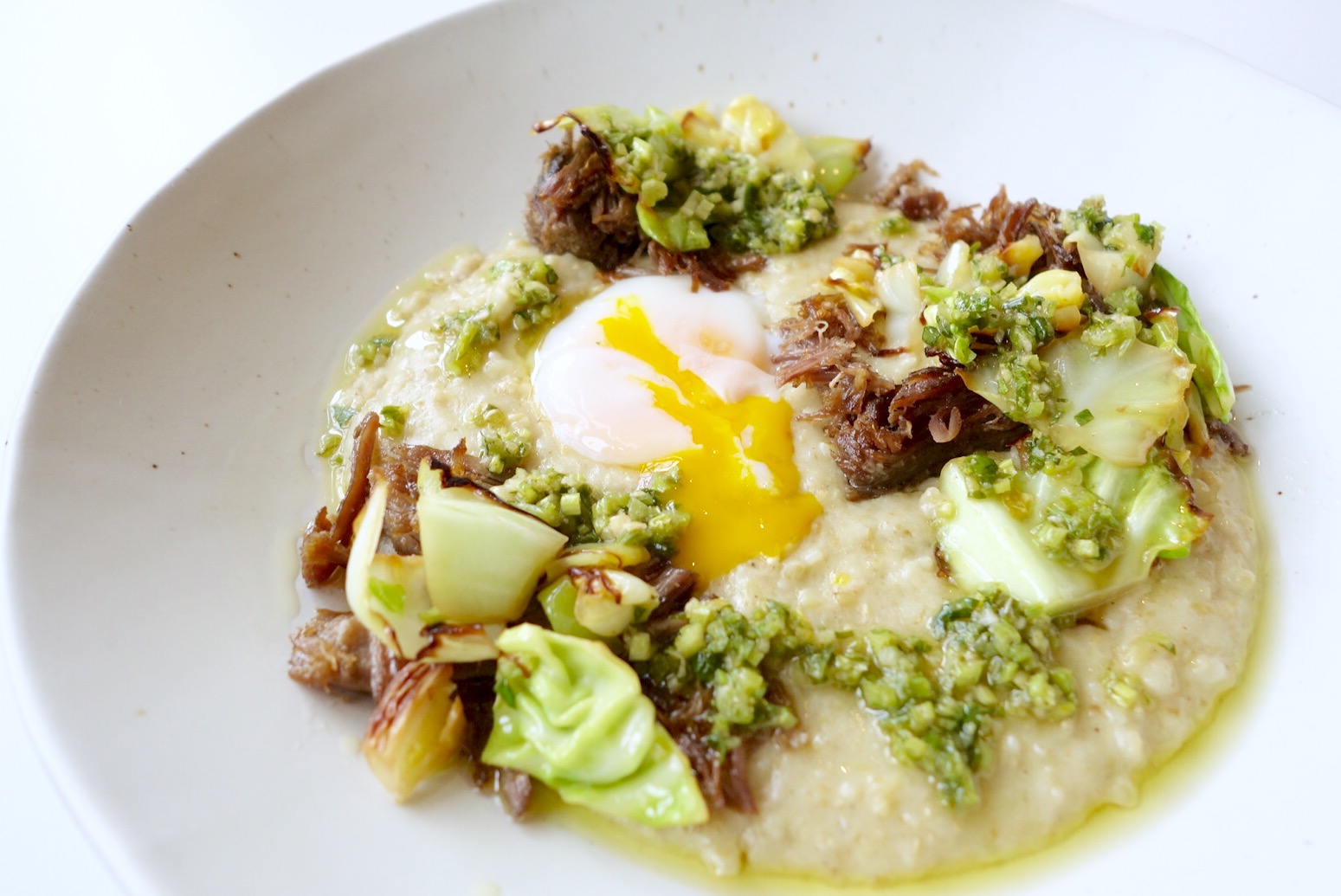 Kismet's freekeh polenta is served with lamb, green chiles, greens and a soft-boiled egg.