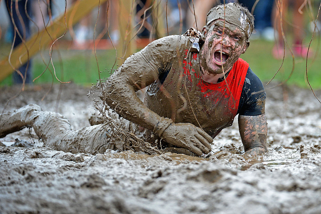 EDINBURGH, SCOTLAND - AUGUST 24: Participents take part in the Tough Mudder endurance event at Dalkieth Country Estate on August 24, 2013 in Edinburgh, Scotland. The world-famous Tough Mudder is military style endurance event over 10-12 miles with various obstacles around the course designed by Briish Special Forces.