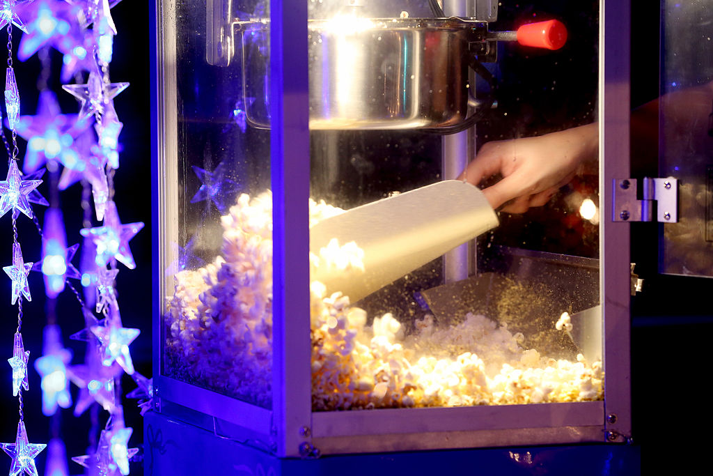 MIAMI, FL - OCTOBER 11: Popcorn is sold from the concession stand while "Back to the Future" plays at The Blue Starlite Mini Urban Drive-In on October 11, 2013 in Miami, Florida. Many traditional drive-in theaters around the United States have closed but the owner of The Blue Starlite held a grand opening for his small outdoor facility, which can accommodate 20 to 24 cars and has seats near the front of the viewing area, with hopes it will become popular in the urban core of Miami. (Photo by Joe Raedle/Getty Images)