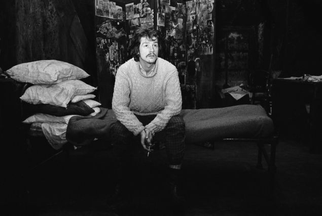 John Hurt, 1966. English actor John Hurt sitting on a bed at the Garrick Theatre.