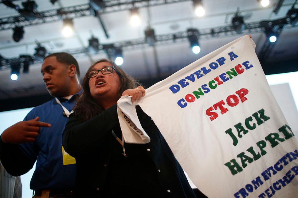 SAN FRANCISCO, CA - JUNE 25: A demonstrator waves a sign in protest of Google during the Google I/O Developers Conference at Moscone Center on June 25, 2014 in San Francisco, California. The seventh annual Google I/O Developers conference is expected to draw thousands through June 26. (Photo by Stephen Lam/Getty Images)