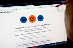 This December 2, 2013 photo shows a woman in Washington, DC reading a message indicating that the HealthCare.gov insurance marketplace internet site has too much traffic to continue enrollment. The troubleshooter appointed by President Barack Obama to overhaul a bungled health care website rollout said Sunday that improvements had made a "night and day" difference in handling online traffic. The White House has admitted previously that the launch of Healthcare.gov, where people can sign up for health insurance, was a debacle and the Obama administration pledged that the vast majority of potential customers would be able to enroll online by the end of November. AFP PHOTO / Karen BLEIER (Photo credit should read KAREN BLEIER/AFP/Getty Images)