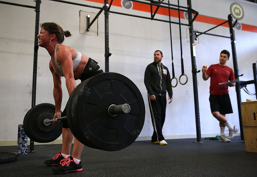 SAN ANSELMO, CA - MARCH 14: Stephanie St Claire does a deadlift during a CrossFit workout at Ross Valley CrossFit on March 14, 2014 in San Anselmo, California. CrossFit, a high intensity workout regimen that is a constantly varied mix of aerobic exercise, gymnastics and Olympic weight lifting, is one of the fastest growing fitness programs in the world. The grueling cult-like core strength and conditioning program is popular with firefighters, police officers, members of the military and professional athletes. Since its inception in 2000, the number of CrossFit affiliates, or "boxes" has skyrocketed to over 8,500 worldwide with more opening every year. (Photo by 