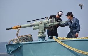 Crew of a whaling ship check a whaling gun or harpoon before departure at Ayukawa port in Ishinomaki City on April 26, 2014. A Japanese whaling fleet left port on April 26 under tight security in the first hunt since the UN's top court last month ordered Tokyo to stop killing whales in the Antarctic. AFP PHOTO / KAZUHIRO NOGI (Photo credit should read KAZUHIRO NOGI/AFP/Getty Images)