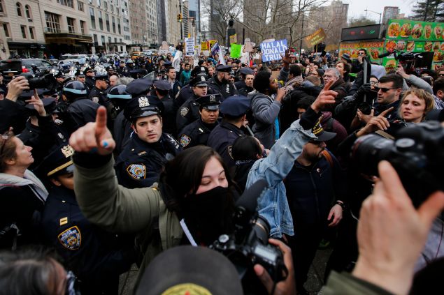 People clash with protesters while they take part in a march against Republican presidential candidate Donald Trump, on March 19, 2016 in New York City. People protest against Trump's policies which threaten the Immigration system and many of the Latino, Black, LGBT, Muslim, and other communities.