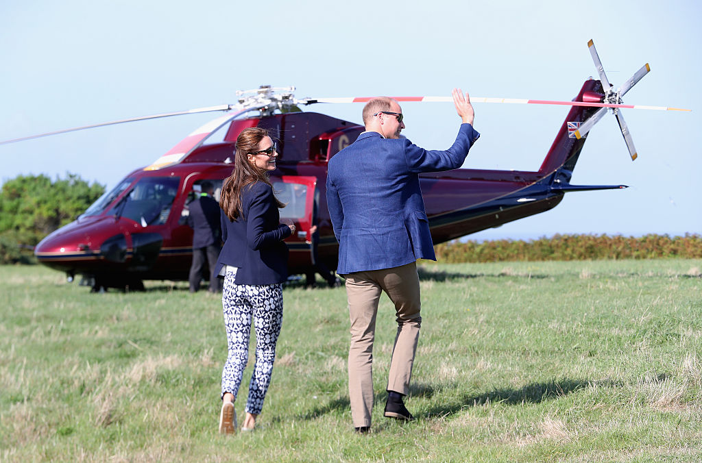 Prince William, Duke of Cambridge and Catherine, Duchess of Cambridge wave as they head back to the Royal helicopter after visiting the Island of St Martin's in the Scilly Isles on September 2, 2016 in St Martins, England. The Duke and Duches's visit to the Scilly Isles was delayed this morning due to bad weather. (Photo by Chris Jackson - WPA Pool/Getty Images)