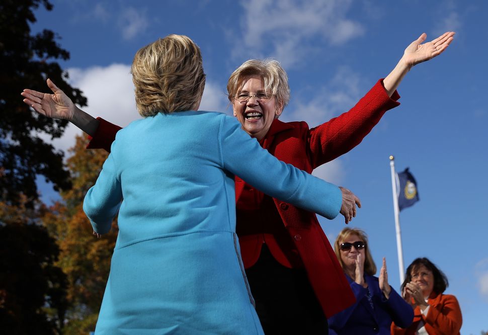 U.S. Sen. Elizabeth Warren greets democratic presidential nominee former Secretary of State Hillary Clinton during a campaign rally at Saint Anselm College on October 24, 2016 in Manchester, New Hampshire.