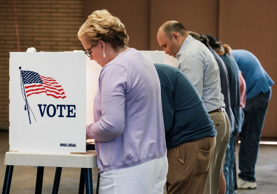Voters cast their ballots in the US presidential election at a fire station in Alhambra, California, on November 8, 2016.