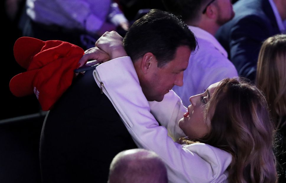 Supporters of Donald Trump embrace during the election night event on November 8, 2016 in New York City, campaign hats in hand.