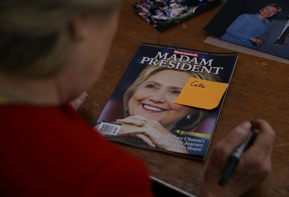 Hillary Clinton signs Newsweek 'Madam President' commemorative magazine on November 7, 2016. Clinton lost the election to Republican nominee Donald Trump.