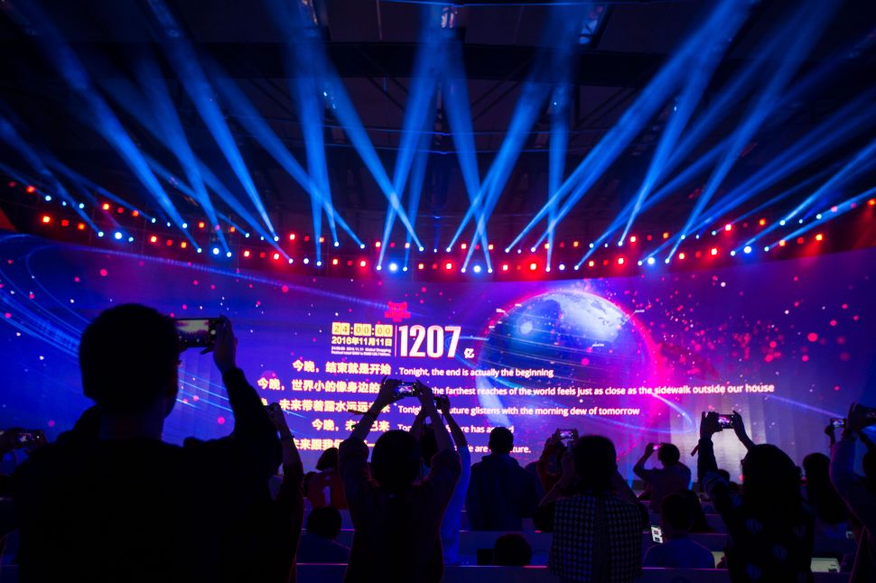 A large screen shows the final total gross merchandise volume, a measure of sales, after 24 hours of Singles Day sales, at the Tmall 11:11 Global Shopping Festival gala in Shenzhen, in south China's Guangdong province early on November 12, 2016.
