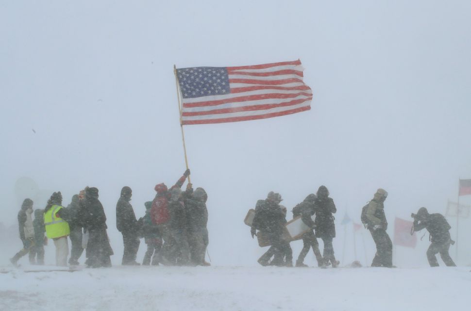 Despite blizzard conditions, military veterans march in support of the "water protectors" on the edge of the Standing Rock Sioux Reservation.