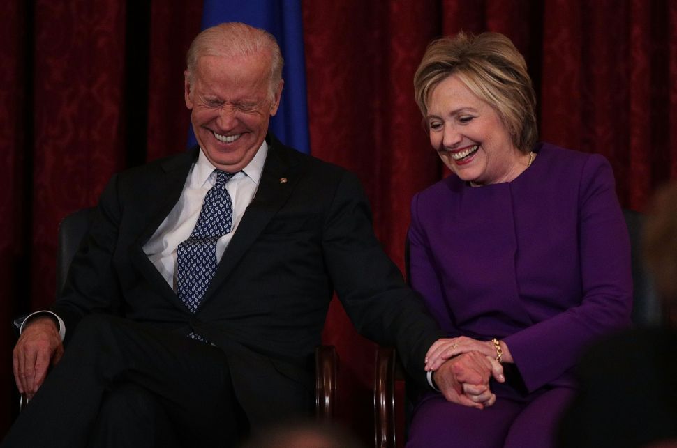 WASHINGTON, DC - DECEMBER 08: Former U.S. Secretary of State Hillary Clinton (R) shares a moment with Vice President Joseph Biden (L) during a leadership portrait unveiling ceremony for Senate Minority Leader Sen. Harry Reid (D-NV) December 8, 2016 on Capitol Hill in Washington, DC. The leadership portrait unveiling ceremony was held to honor the outgoing Democratic leader.