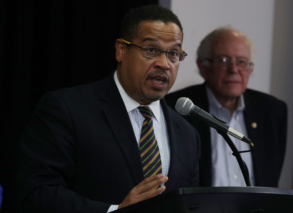 U.S. Rep. Keith Ellison speaks as Sen. Bernie Sanders listens during an event that was held to outline Ellison’s vision as he campaigns to become the next chairman of the Democratic National Committee.