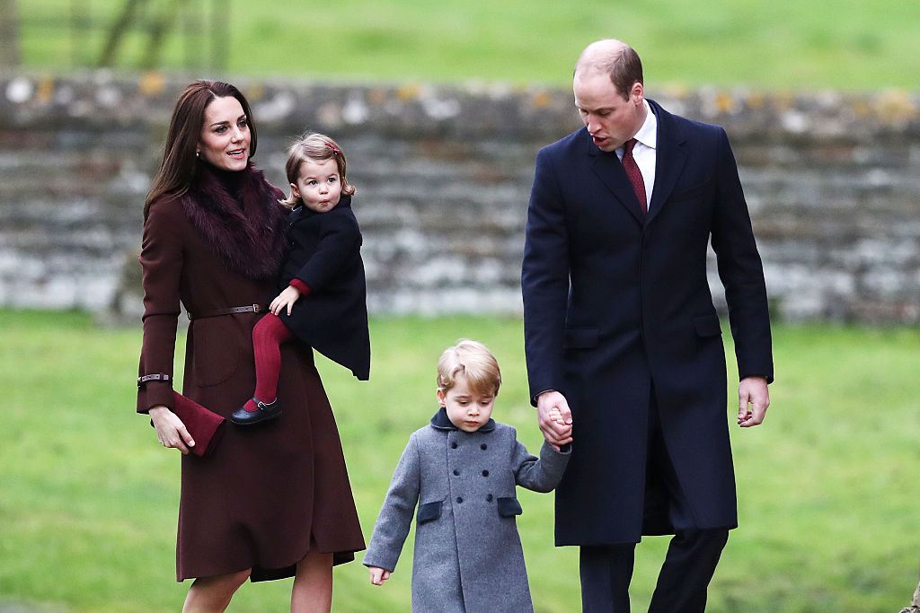 TOPSHOT - Britain's Prince William (R), Duke of Cambridge and Catherine, Duchess of Cambridge arrive with Prince George (C) and Princess Charlotte to attend a Christmas Day service at St Mark's Church in Englefield on December 25, 2016. / AFP / POOL / Andrew Matthews (Photo credit should read ANDREW MATTHEWS/AFP/Getty Images)