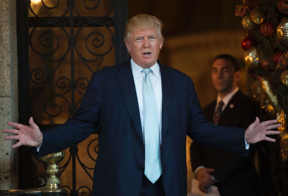 US President-elect Donald Trump answers questions from the media after a day of meetings on December 28, 2016 at Mar-a-Lago in Palm Beach, Florida.