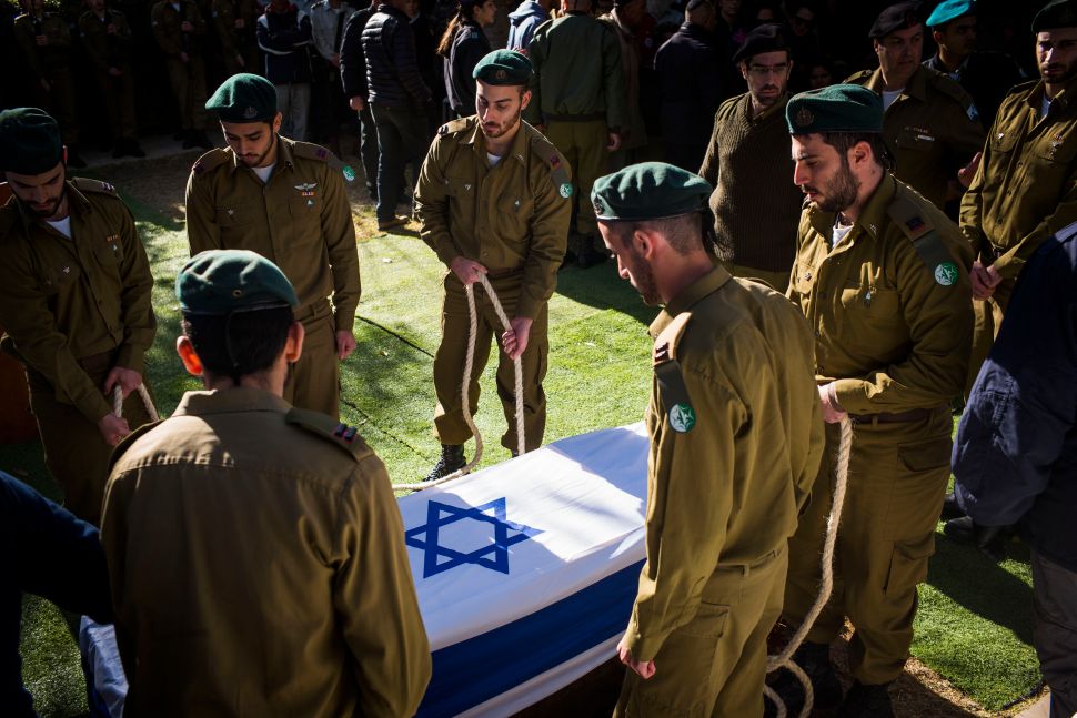 JERUSALEM, ISRAEL - JANUARY 09: The coffin of Shira Hajaj is lowered during her funeral on January 9, 2017 in Jerusalem, Israel. Hajaj was one among the four soldiers killed during the truck attack the previous day.