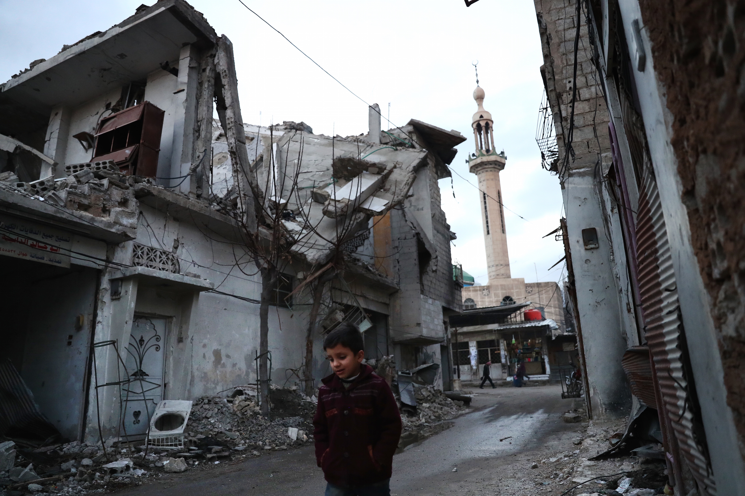 A Syrian boy walks in a street in the rebel-held town of Douma, on the eastern outskirts of the capital Damascus, on January 9, 2017.