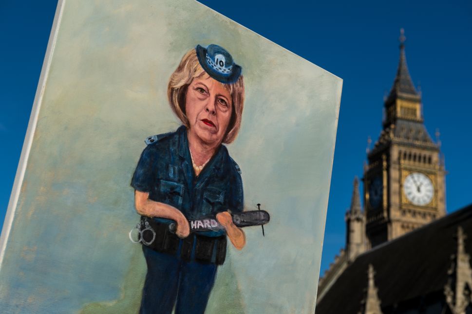LONDON, ENGLAND - JANUARY 17: Artist Kaya Mar holds his latest painting of Theresa May dressed as a police officer holding a truncheon with 'Hard Brexit' written on it in front of the Houses of Parliament on January 17, 2017 in London, England. Today in a long awaited speech, British Prime Minister Theresa May outlined the prioirites for the United Kingdom in Brexit negotiations.