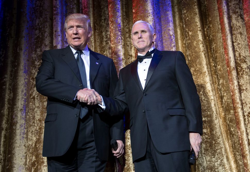 WASHINGTON, DC - JANUARY 17: President-elect Donald Trump (L) and Vice President-elect Mike Pence arrive on stage at the Chairman's Global Dinner, at the Andrew W. Mellon Auditorium on January 17, 2017 in Washington, DC. The invitation-only black-tie event offered an opportunity for Trump to introduce himself and members of his cabinet to foreign diplomats. 