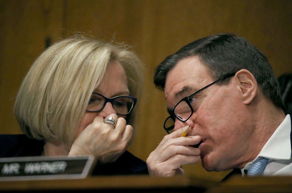 Sen. Claire McCaskill talks with Sen. Mark Warner during the confirmation hearing of Treasury Secretary nominee, Steven Mnuchin, on January 19, 2017.