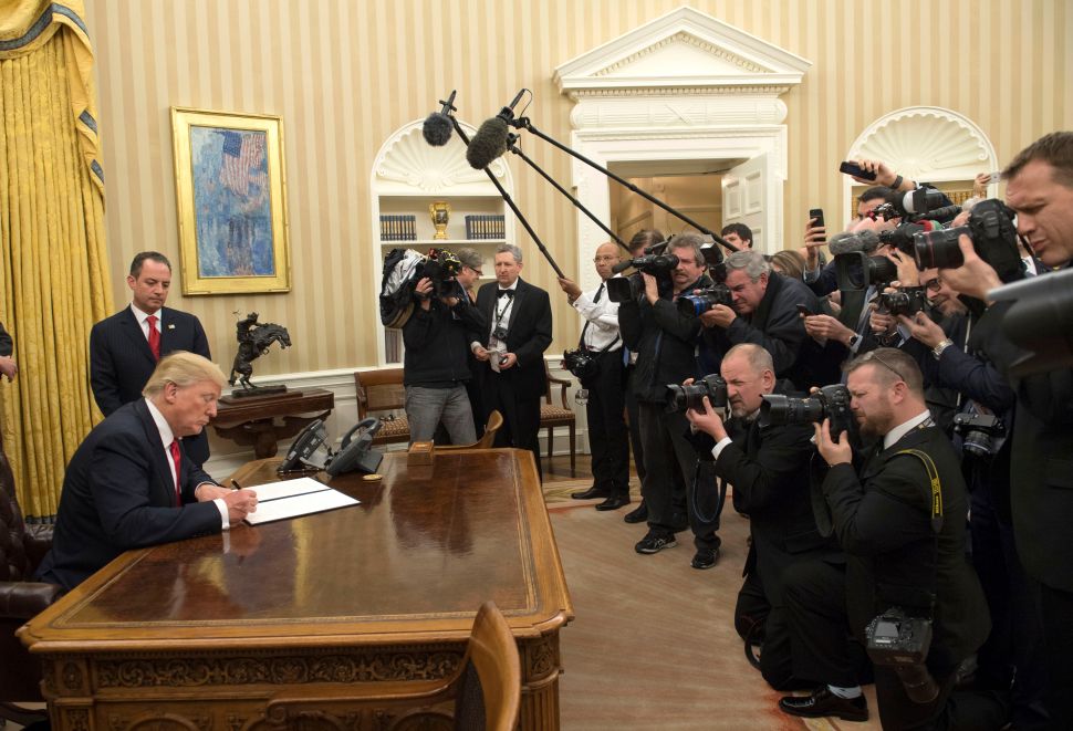 WASHINGTON, DC - JANUARY 20: President Donald Trump signs his first executive order as president, ordering federal agencies to ease the burden of President Barack Obama's Affordable Care Act January 20, 2017 in Washington, DC.