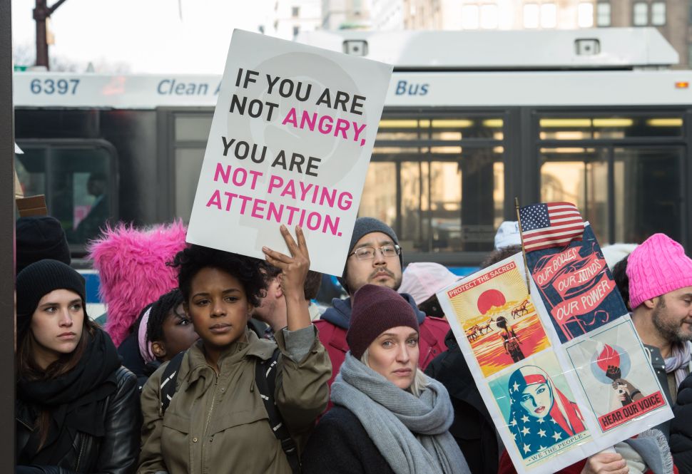 People are blocked from passing Trump Tower during the Women's March in New York City on January 21, 2017. Hundreds of thousands of people flooded US cities Saturday in a day of women's rights protests to mark President Donald Trump's first full day in office. / AFP / Bryan R. Smith