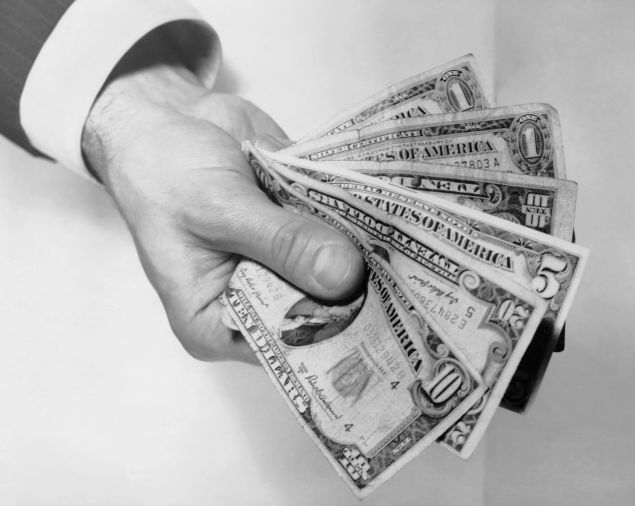 Hand holding out money.