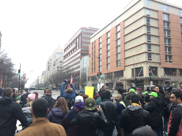 Protesters and police officers with riot gear on K Street between 11th and 12th streets in Washington, D.C.