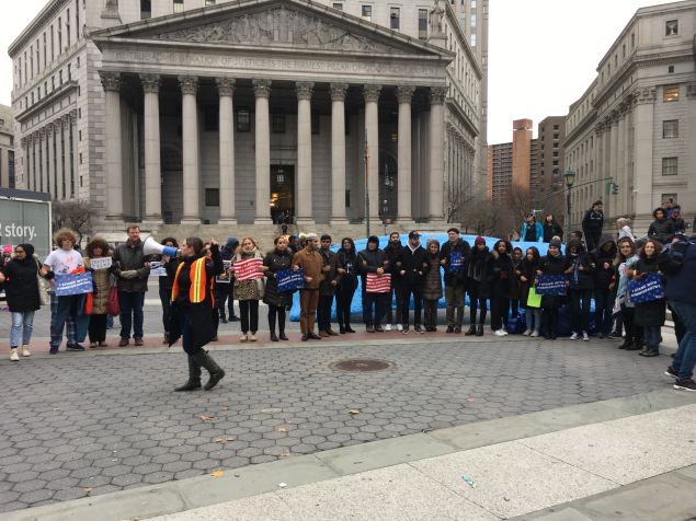 Carlene Pinto, the New York Immigration Coalition's immigration campaign manager, directs attendees to form a human chain in Foley Square.