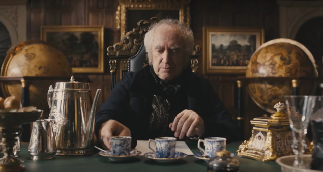The East India Company's Sir Stuart Strange (Jonathan Pryce) sips tea from imported china.