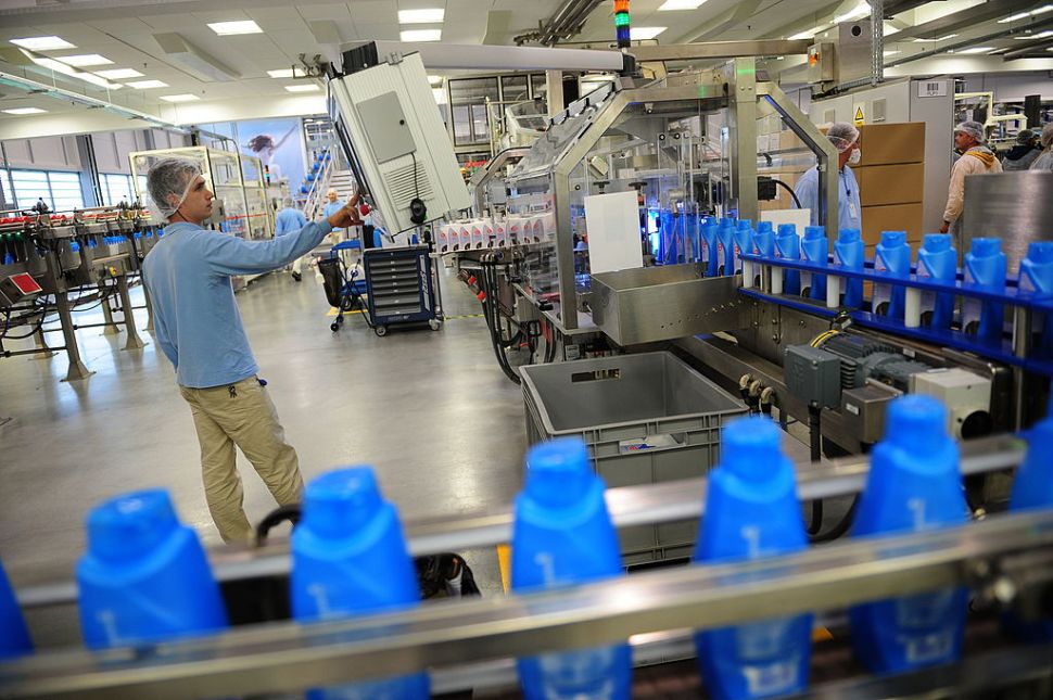 A Romanian employee surveys a production line at a Procter & Gamble plant in Bucharest.