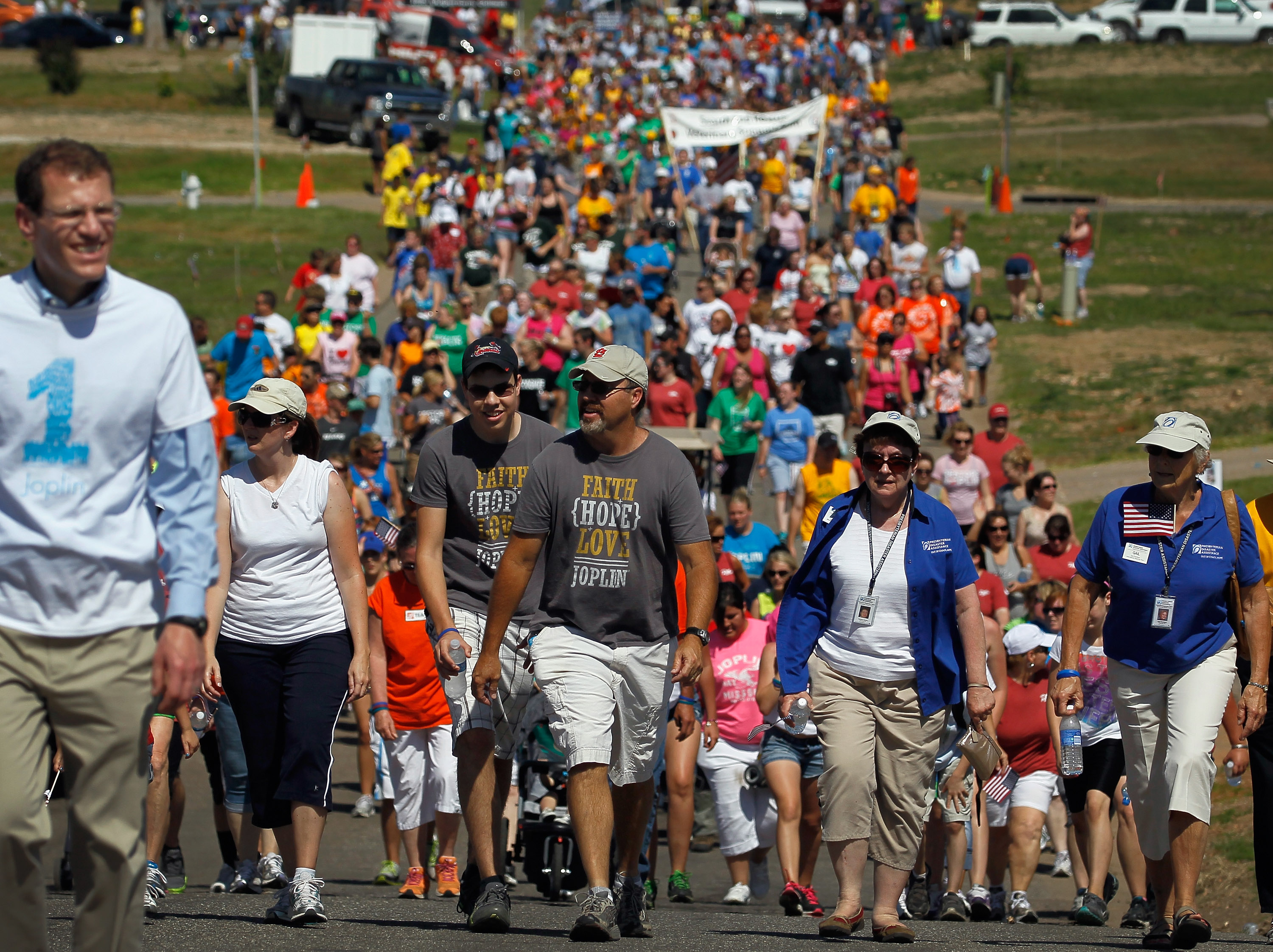 In a 2012 ceremony, residents of Joplin, Missouri walk the route of a massive tornado that ripped through the town a year earlier, killing 161 people.