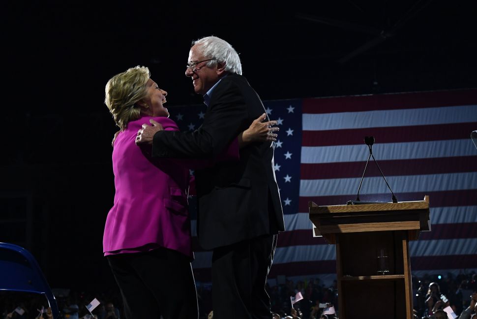 Hillary Clinton embraces Sen. Bernie Sanders.