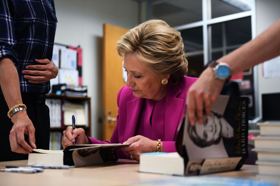 Hillary Clinton signs copies of her books for her supporters.