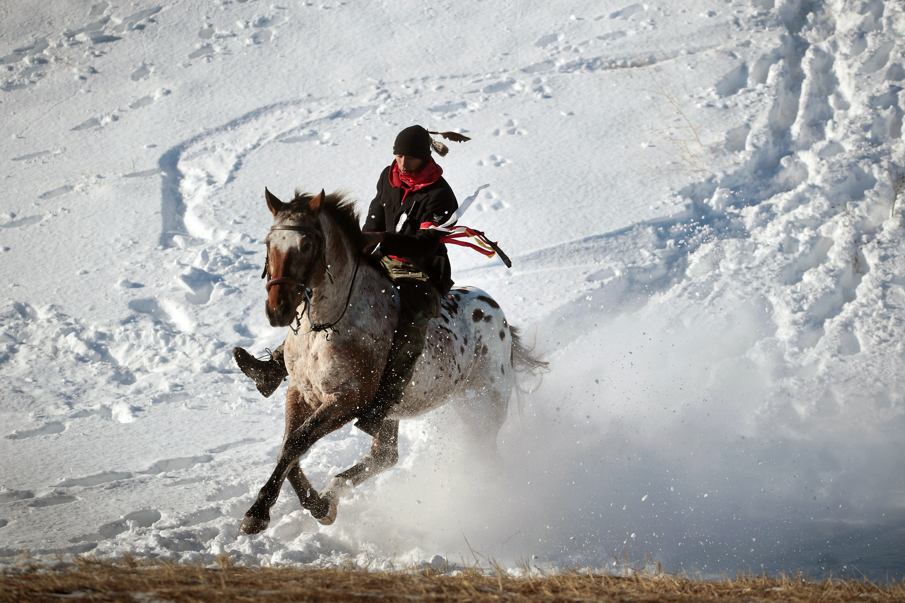 Native American activist rides down a ridge which overlooks Oceti Sakowin Camp on the edge of the Standing Rock Sioux Reservation on December 4, 2016 outside Cannon Ball, North Dakota.