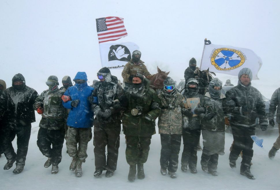 A large group of military veterans join Native Americans and activists from around the country to try to halt the construction of the Dakota Access Pipeline.