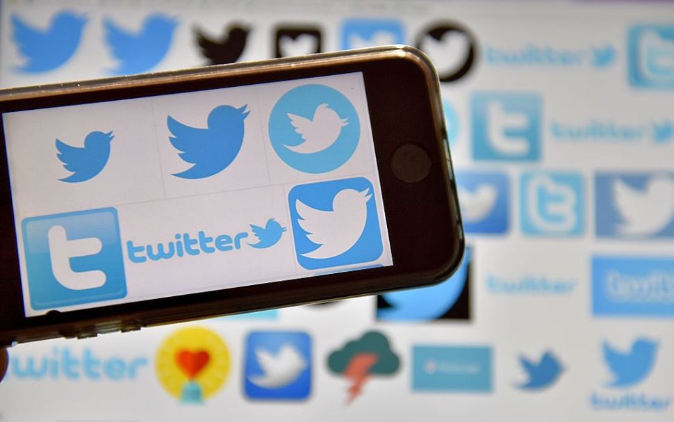 A picture taken on December 28, 2016 in Vertou, western France, shows logos of US online news and social networking service Twitter.