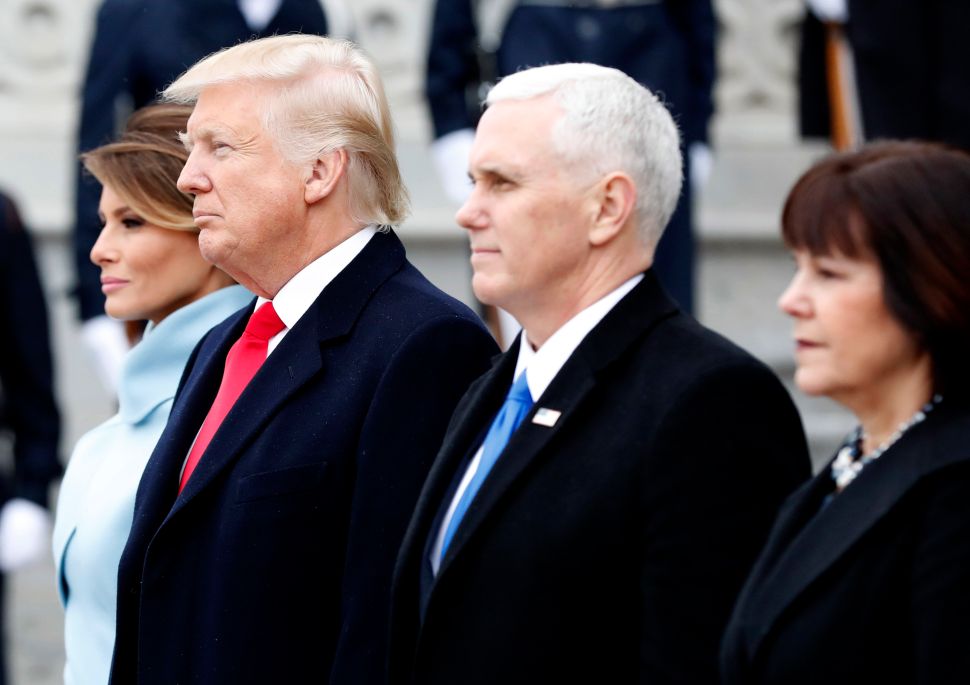 President Donald Trump, First Lady Melania Trump, Vice President Mike Pence and Karen Pence stand on front steps of the Capitol Building.